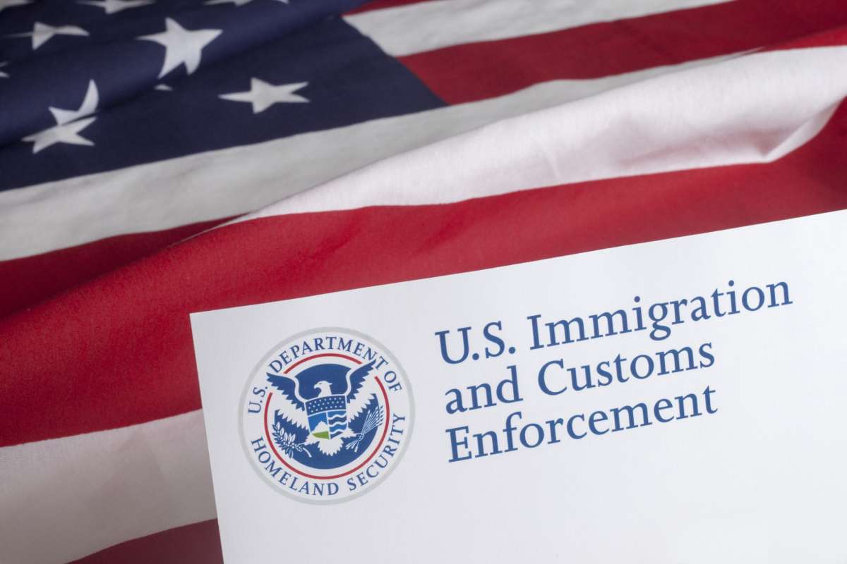 Closeup of a letterhead for ICE on a US flag