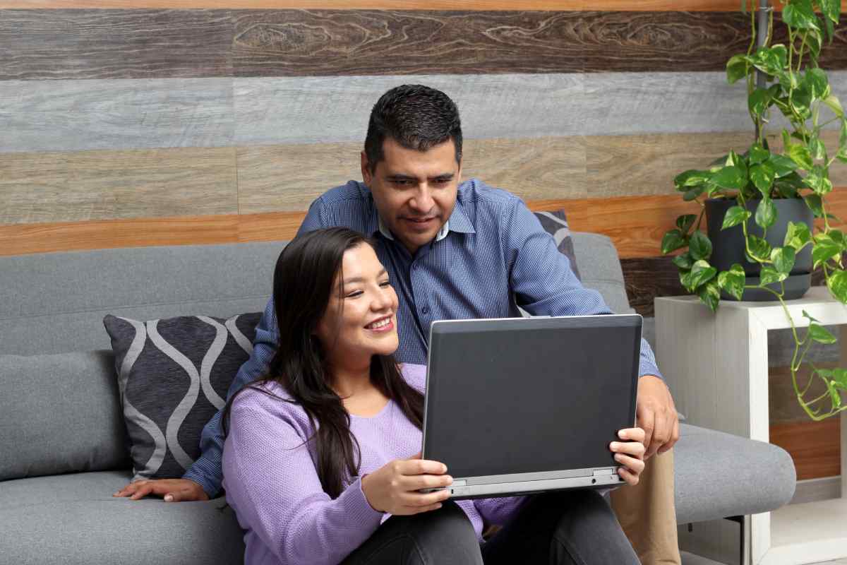 Woman and man reviewing documents on a laptop