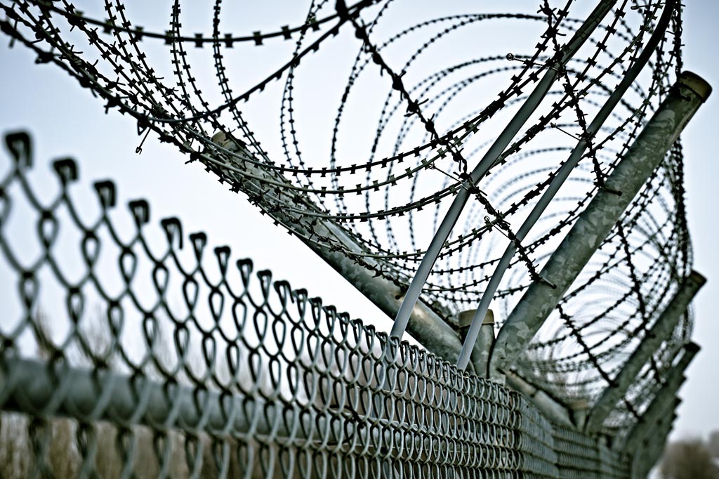 Border fence with barbed wire.