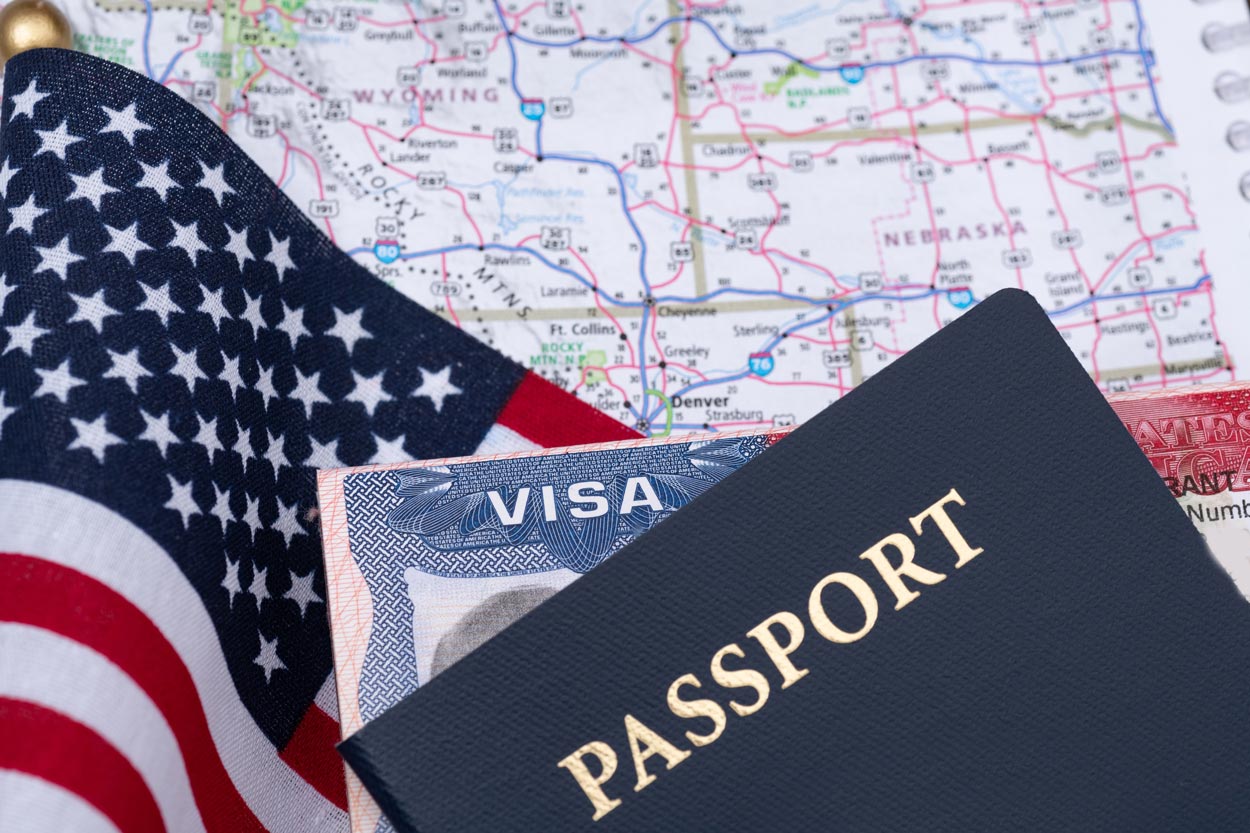 Passport with a US Visa against the background of the flag and map of the United States