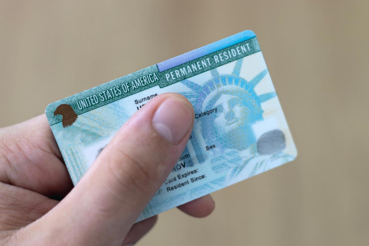 Closeup of hand holding green card